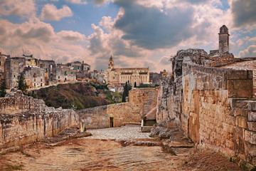 Gravina in Puglia, Bari, Italy: landscape at sunrise of the old town seen from the entrance of the ancient aqueduct bridge