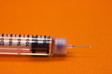 injector pen, insulin needle in orange background