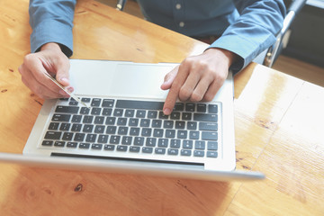 Business people are using their notebooks to find investment information.