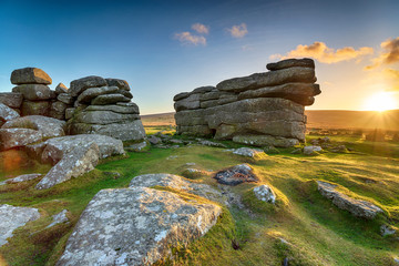 Beautiful sunset over granite rock formations at Combestone Tor