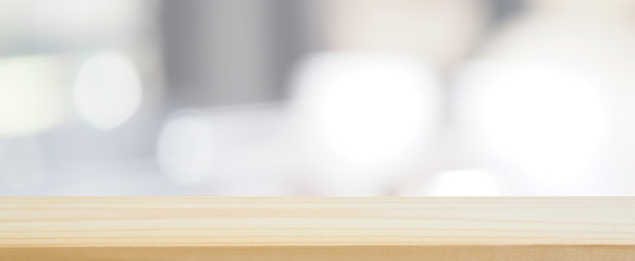 wood plank table top on blur and bokeh abstract kitchen window glass using for banner design and...