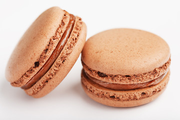 Chocolate macaroni cookies on a white background with brown filling, isolated.