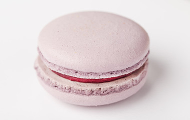 Lilac cookies macaroni on a white background of brown color with filling, isolated.