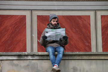 Seated Man looking at map of the most famous places in the city