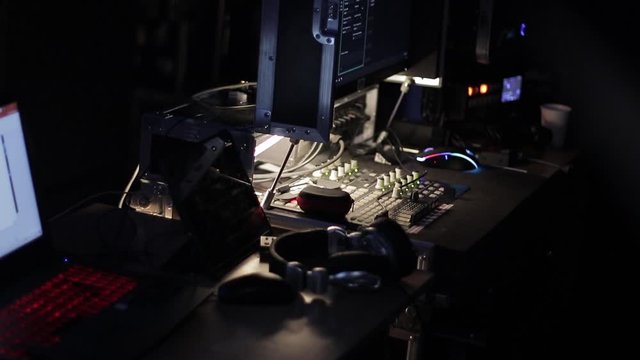 Audio mix desk at a concert. Man working on professional digital audio channel mixer in studio. Male Dj hands playing set in night club party slow motion