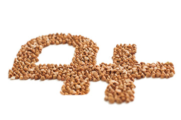 Russian rouble sign made of Buckwheat grains on white background.