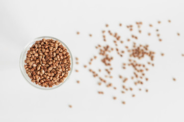 A small glass of buckwheat - traditional Russian meal - on white background.