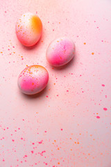 Hand painted easter eggs on pink orange shiny colored paint pattern © Maciek