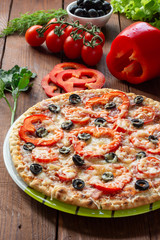 Pizza with olives, tomatoes, ham. Still-life. Assorted pizza