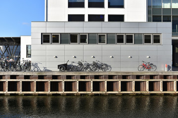 bicycles near office building along embankment