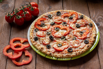 Pizza with olives, tomatoes, ham. Still-life. Assorted pizza