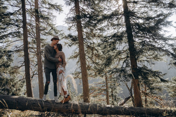 man and woman walking in forest