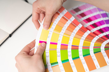 Graphic designer at work chooses color palette