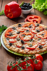 Pizza with olives, tomatoes, ham. Still-life. Assorted pizza