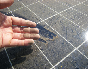 Dirty Hand after Rubbing Dusty Solar Panel