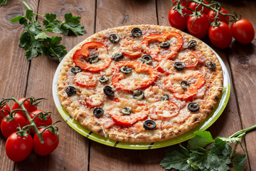 Pizza with olives, tomatoes, ham. Still-life. Assorted pizza
