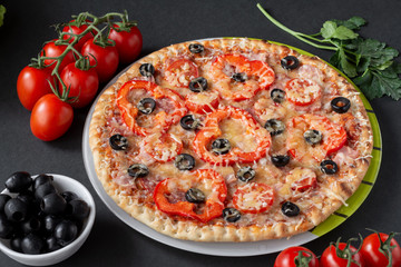 Pizza with olives, tomatoes, ham. Still-life. Assorted pizza