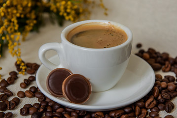 A cup of coffee for breakfast. Coffee beans. Espresso in a white cup.