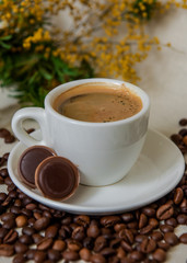 A cup of fresh espresso with chocolates. Coffee beans. Morning coffee concept