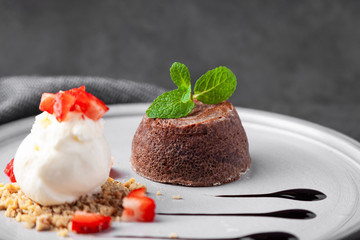 White plate with chocolate fondant cake dessert