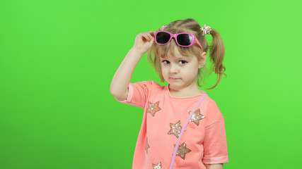 Positive girl in pink blouse and sunglasses posing and make faces. Chroma Key