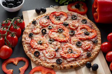 Pizza with olives, tomatoes, ham. Still-life. Assorted pizza