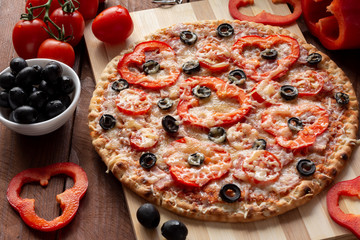 Pizza with olives, tomatoes, ham. Still-life. Assorted pizza