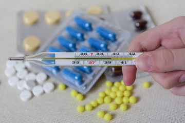 Various medicines in tablets and capsules. Mercury thermometer. Medicine concept. Pharmaceutical...