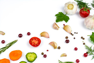 Cucumbers, carrots, berries and vegetables, garlic and fresh tomatoes isolated on a white background.