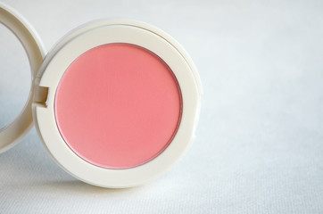 Pink Blush Powder Makeup on white clothing background, cosmetics concept