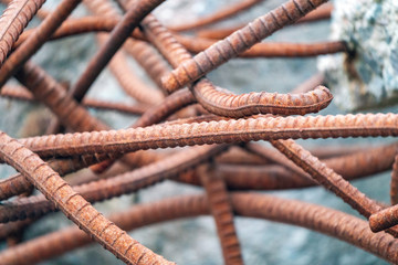 Old and rusty reinforced concrete steel bars with colorful background. Metal, iron and construction concept.