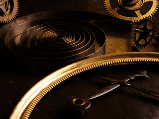 Parts of vintage rare watches, metal spring and hands. Steampank background.