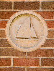 a close up of a boat sculputure in a brick wall