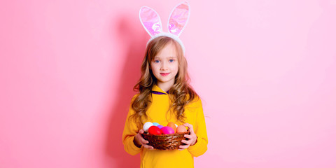 Obraz na płótnie Canvas Banner happy Easter! Little girl having fun to paint Easter eggs.