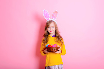 Obraz na płótnie Canvas Happy Easter! Little girl having fun to paint Easter eggs.