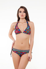 Obraz premium beautiful girl posing in stylish chic colorful bikini on white background.
