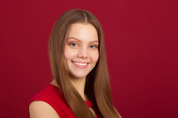 portrait of a beautiful young woman on a red background