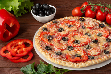 Pizza with olives, tomatoes, ham. Still-life. Assorted pizza