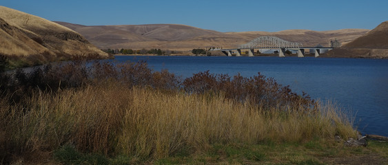 Steel, arched, highway bridge crossing Columbia River in the Palouse of Eastern Washington during dry fall season