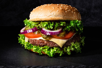 fresh tasty beef burger on dark background