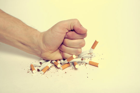 Man crushes cigarettes with his fist refusing to smoke.