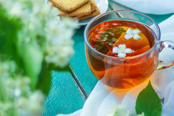 Jasmine tea with jasmine herb flower on wooden table