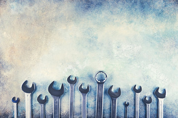Wrench spanner tools on grunge colorful background. Top view, copy space..
