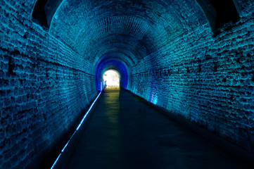 brick train tunnel ceiling with blue lights