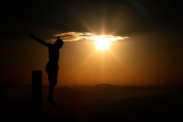  crucified man in mountains at sunset