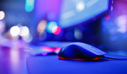 Keyboard and mouse for professional streamer video gamers with computer. Cyber sport championship, neon blue color lights