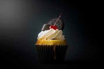 Delicious, fragrant cupcake with drunk cherry and chocolate.