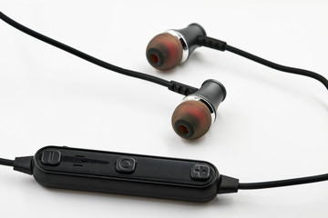 Black red Headset with Remote Control on white background. Closeup, selective focus