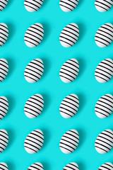 Pattern made of hand drawn eggs on blue pastel background. Easter concept.