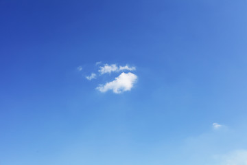 Fototapeta na wymiar small white cloud against blue sky, background